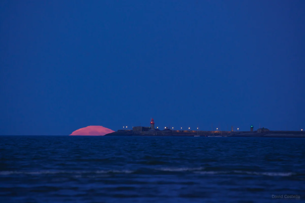 The supermoon moving towards Dun Laoghaire pier.