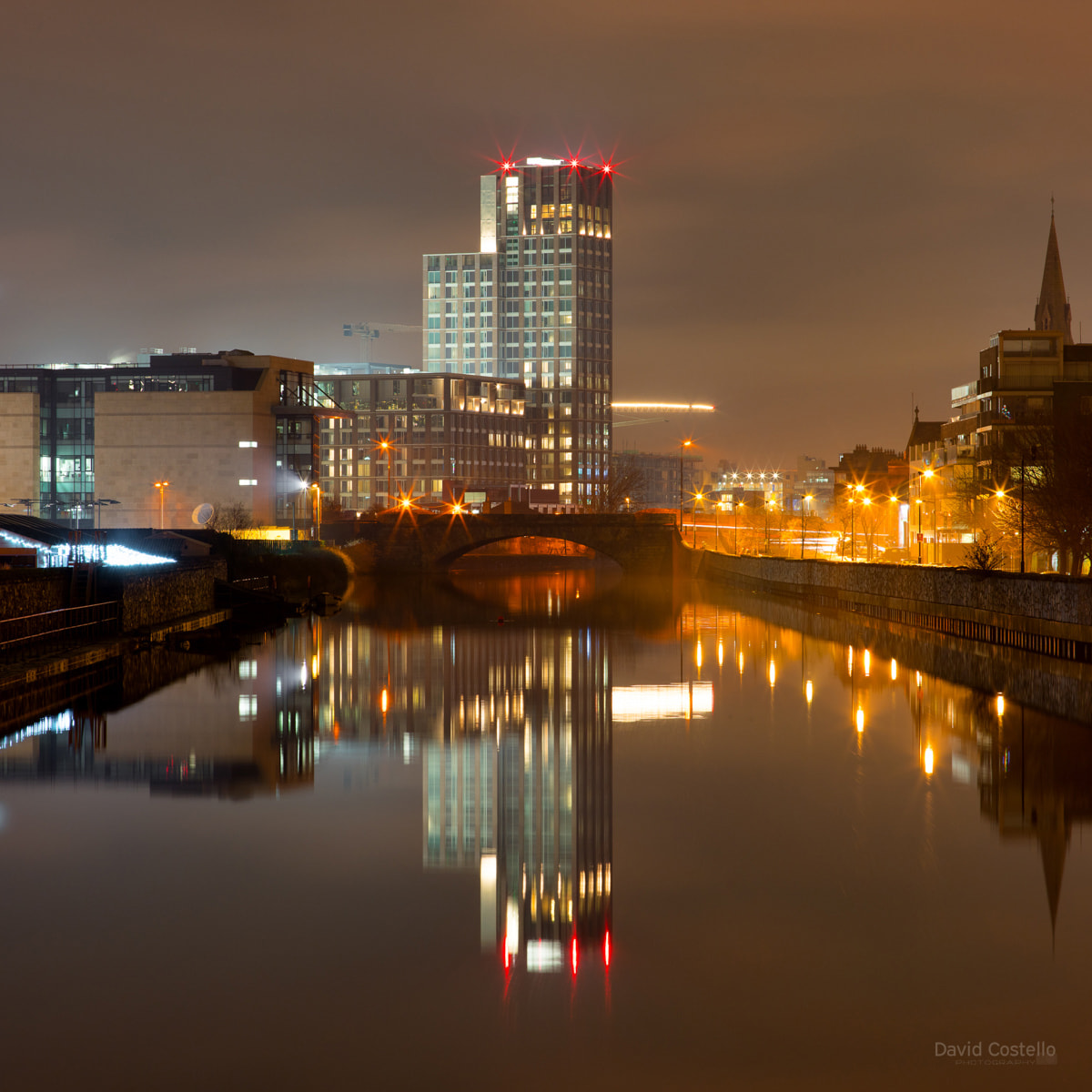 Capital Dock and Ringsend Bridge reflecting in the river Dodder in Dublin.