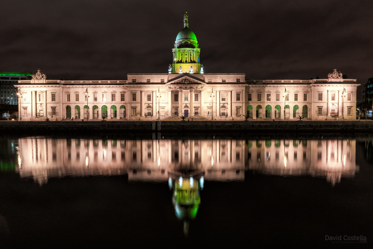 The Custom House lit up in green for the 2017 St. Patrick's Day celebrations as the light reflected across the river Liffey.