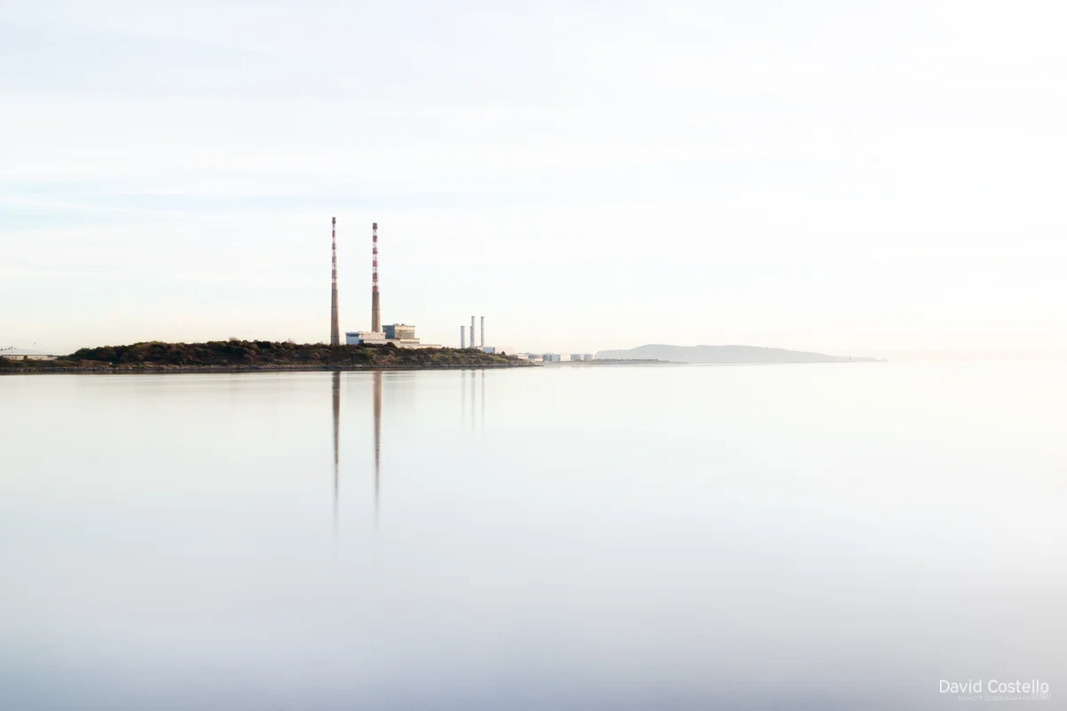A frosty calm winter morning looking out from Sandymount Strand towards the Dublin Towers reflecting in the water.