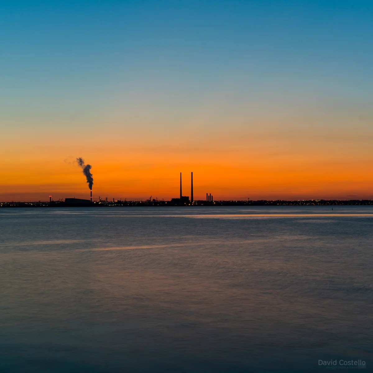 After sunset on a summer evening looking across Dublin bay from Dun Laoghaire pier towards the Chimneys and the sunset.