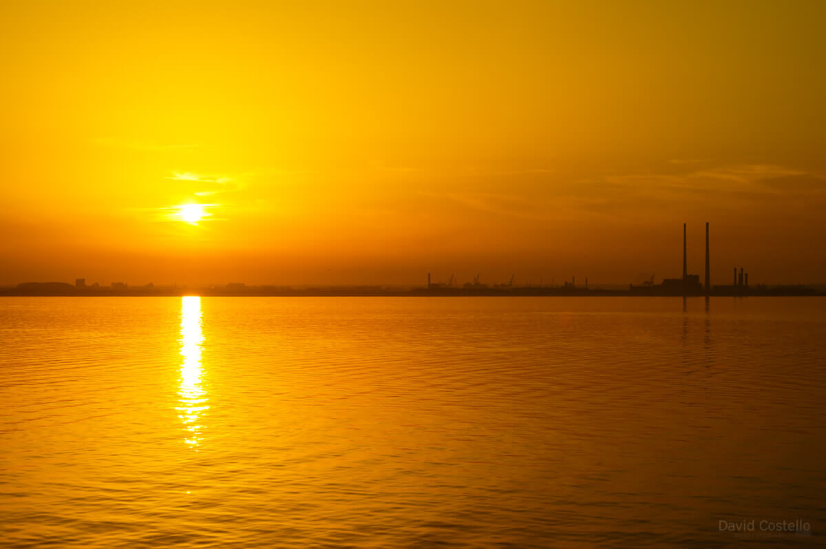 The sun setting over Dublin Bay on the longest day of the year from Dun Laoghaire pier in June 2013.