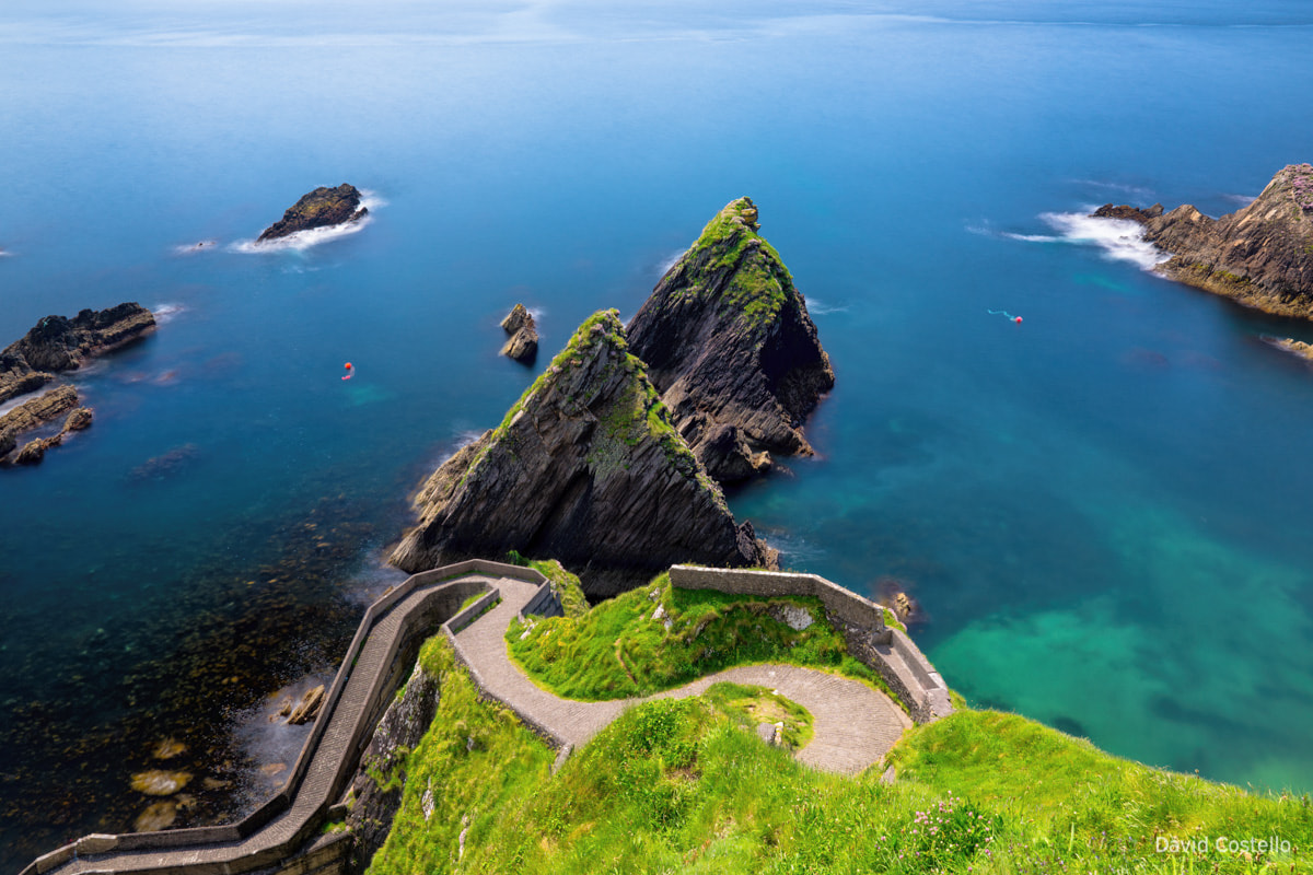 The winding road leading to Dunquin pier, on the edge of Dingle Peninsula and the spectacular view out over Dunquin bay.