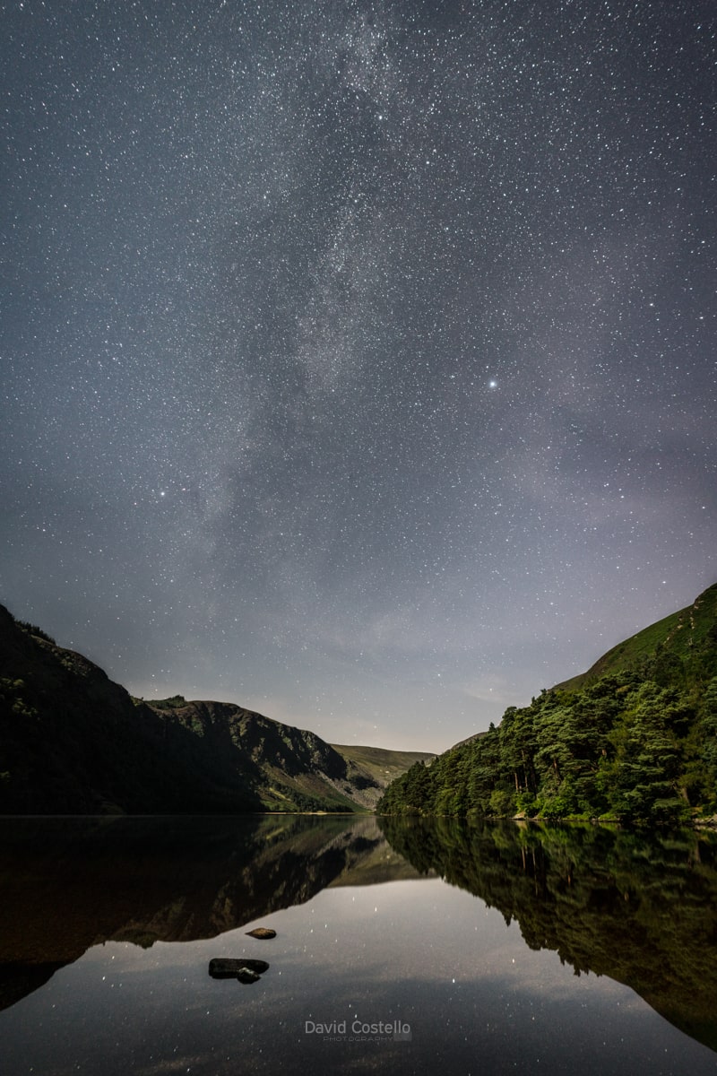 Glendalough Upper Lake on a beautiful summer's night as the Milky Way rose over the valley and reflected in the calm waters.