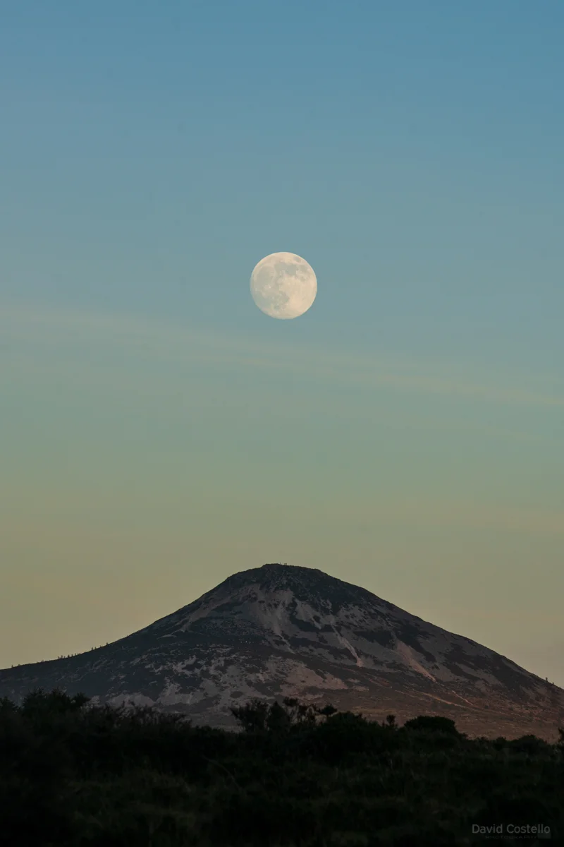The Great Sugar Loaf mountain as the Moon rises on a beautiful January afternoon as the sun began to set in Wicklow.