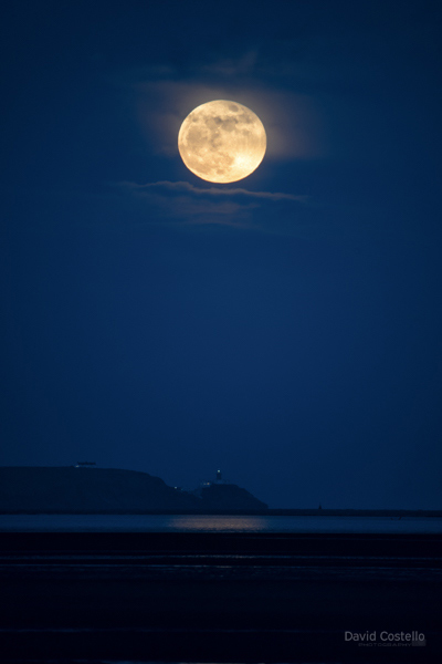 The Full Moon rising above the Baily Lighthouse.
