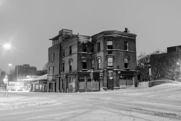 Baggot Street junction covered in snow late on a winter night.