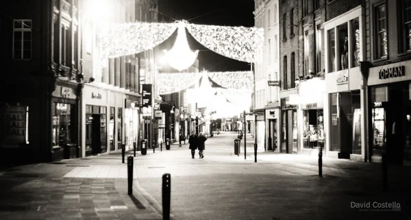 Grafton Street with two people walking alone along it on Christmas Day.