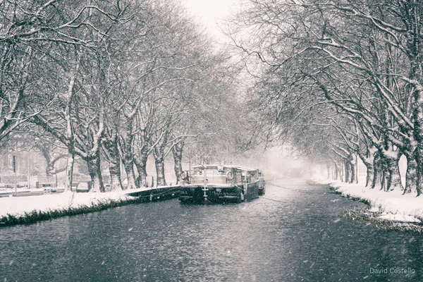 The Grand Canal and barge covered in falling Snow.