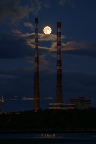 A picture of the Full Moon at the Poolbeg Chimneys in 2023.