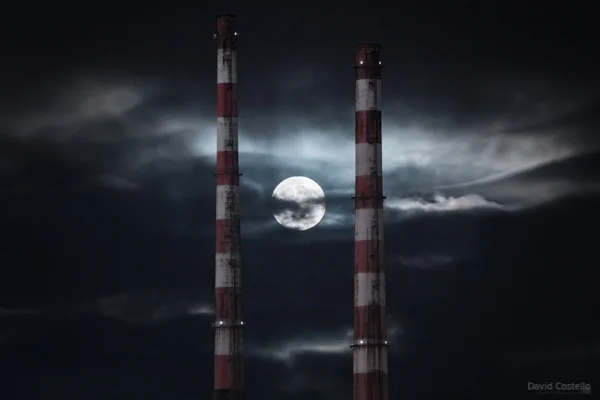 The moonrise in the middle of the Poolbeg Towers.