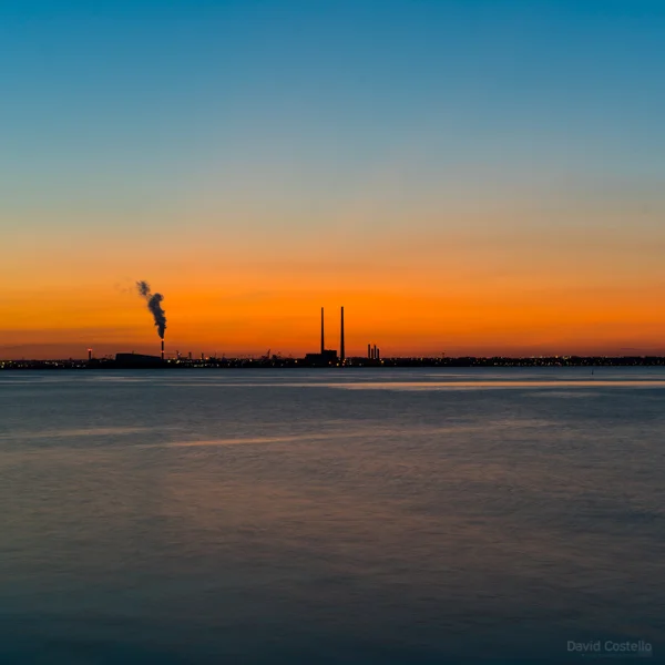 Across Dublin Bay towards The Pigeonhouse as the sky turns from orange to blue at sundown.