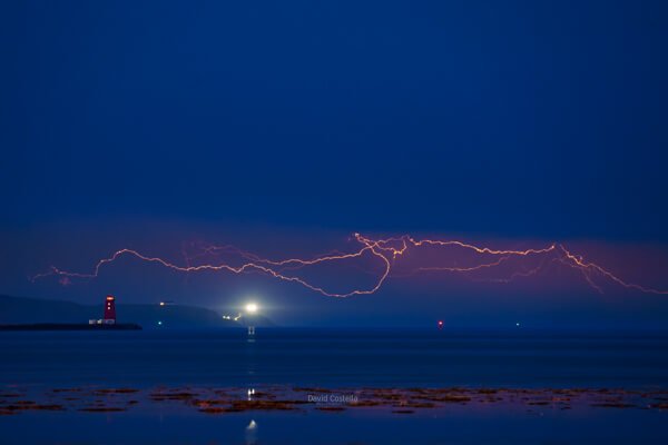 Poolbeg Lighthouse & Howth as lightning rolled up the Irish Sea.