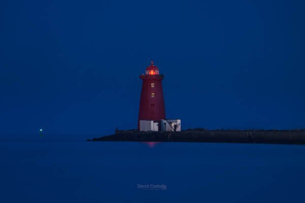The Poolbeg Lighthouse illuminated as the sun rises on a perfect Spring morning in Dublin.