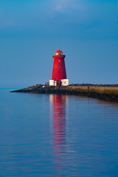 A warm summer evening as Poolbeg Lighthouse reflects in Dublin bay.