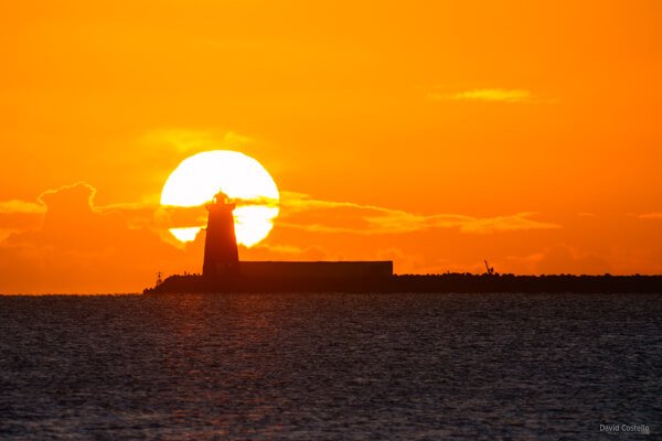 The view from Clontarf Promenade of Poolbeg Lighthouse at Sunrise on a freezing January morning.