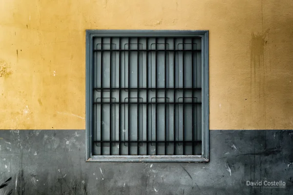 A closed shuttered window in a French town.