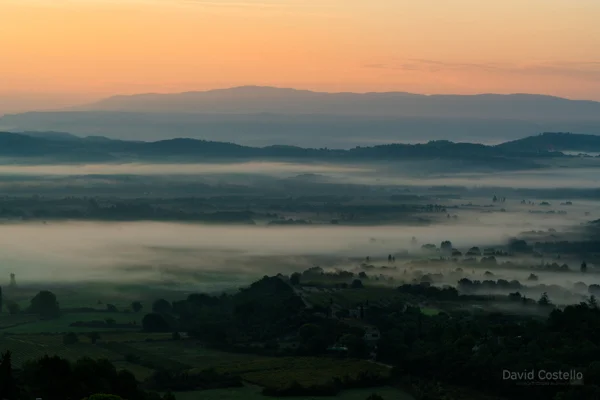 A misty dawn sunrise setting looking over the landscape, vallys and vineyards of Cote d'Azur.