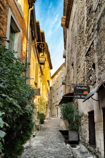 The sunrise just touches the buildings along Rue du Four as daylight arrives in Provence.