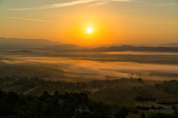The sunrise across the valleys and vineyards of Cote d'Azur from the town view point in Gordes.