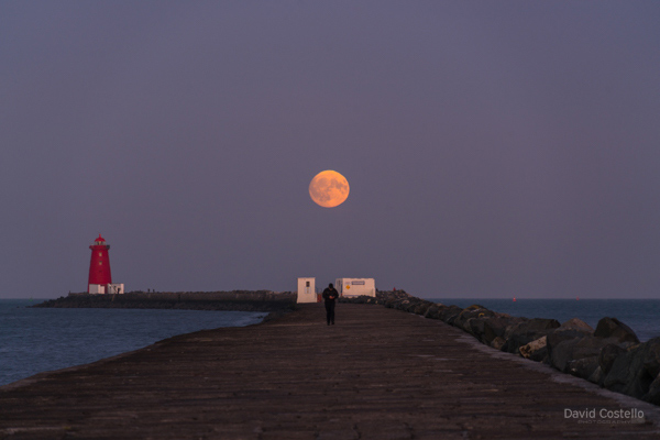 The Full Moon rising above the half moon swimming club on the Great South Wall.