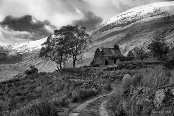 Mollys Cottage & the road leading to the abandoned cottage in the Black Valley with a backdrop of the Macgillycuddy's Reeks.