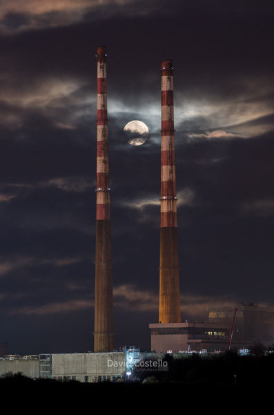 The Full Moon rising between the Poolbeg Chimneys.